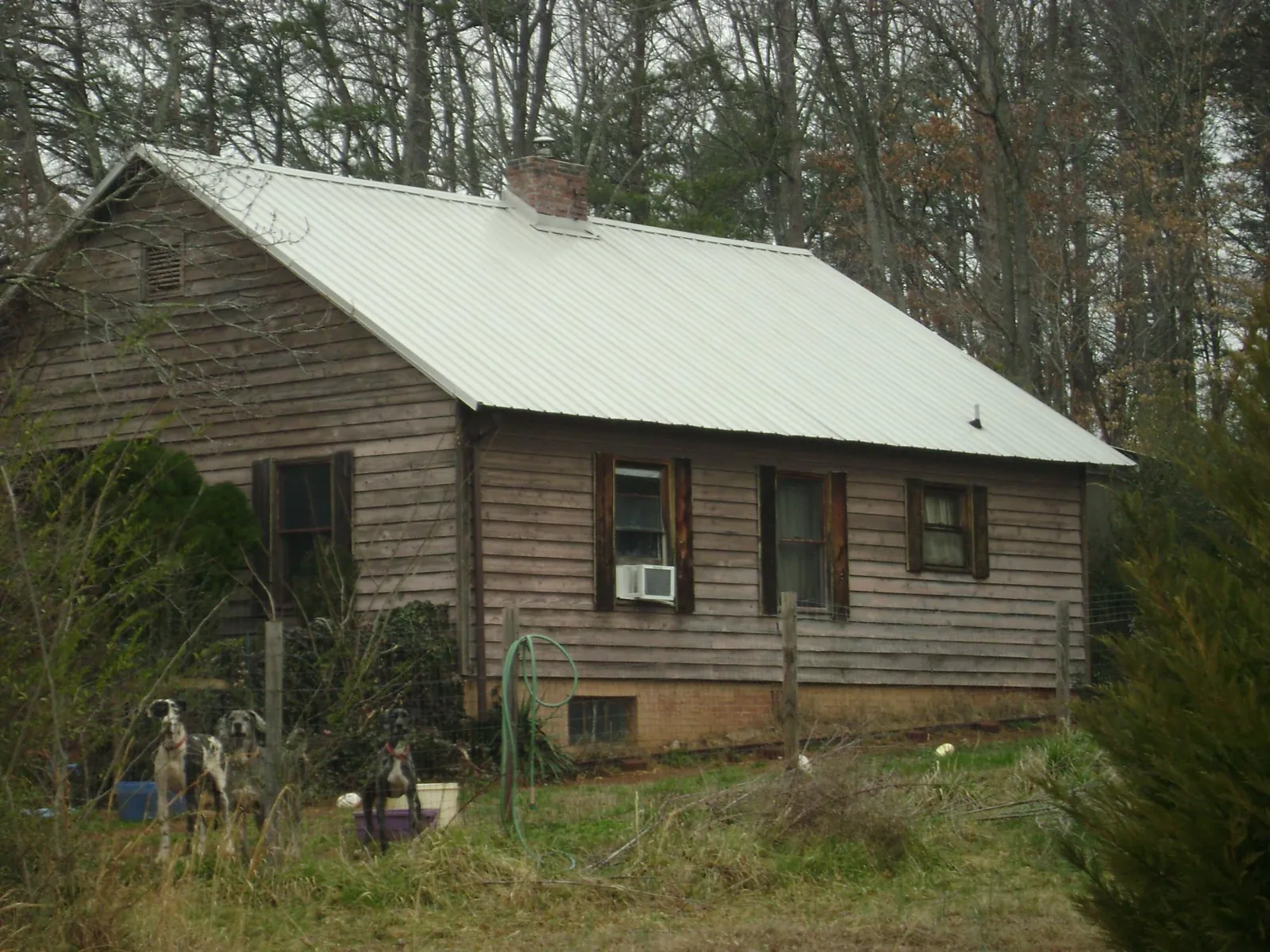 White metal roof on an old wood sided farmhouse, from a Metal Roof Installation job in North Baltimore